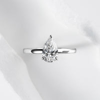 A platinum band with a pear cut solitaire laboratory grown diamond.