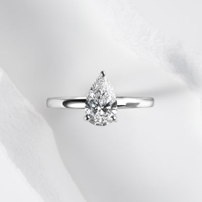 A platinum band with a pear cut solitaire laboratory grown diamond.